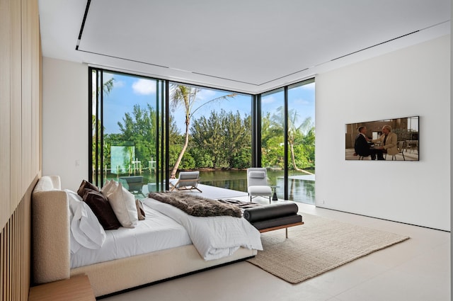 bedroom featuring expansive windows and access to exterior