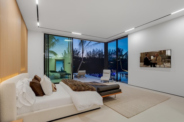 bedroom featuring access to exterior and floor to ceiling windows