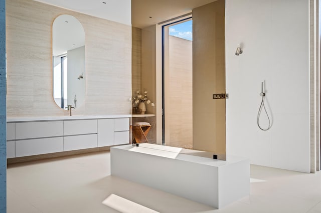 full bathroom featuring tile walls and vanity