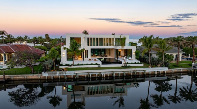35 Spoonbill Rd, Manalapan, FL 33462 - back of property featuring a water view, a patio area, and a yard