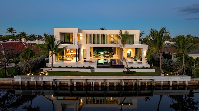 35 Spoonbill Rd, Manalapan, FL 33462 - rear view of house featuring a balcony, a patio area, stucco siding, and a lawn