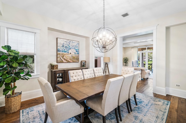 dining space with dark wood-type flooring, coffered ceiling, beam ceiling, and a chandelier