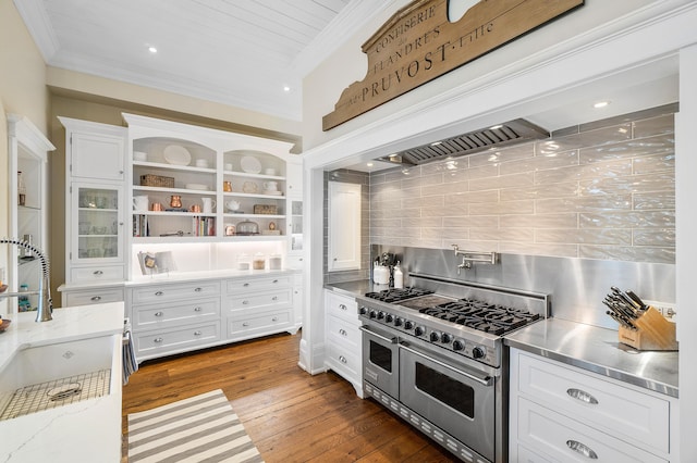 kitchen with range with two ovens, dark hardwood / wood-style floors, decorative backsplash, light stone counters, and white cabinetry