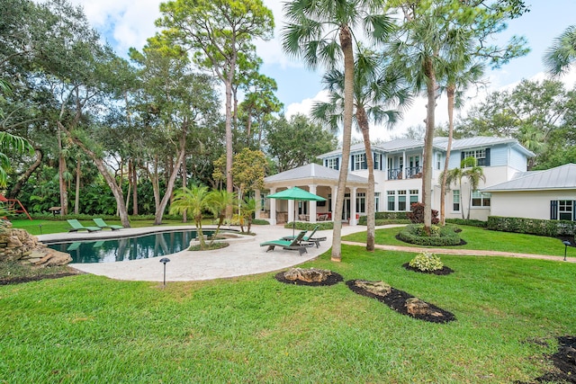 view of swimming pool with a yard and a patio