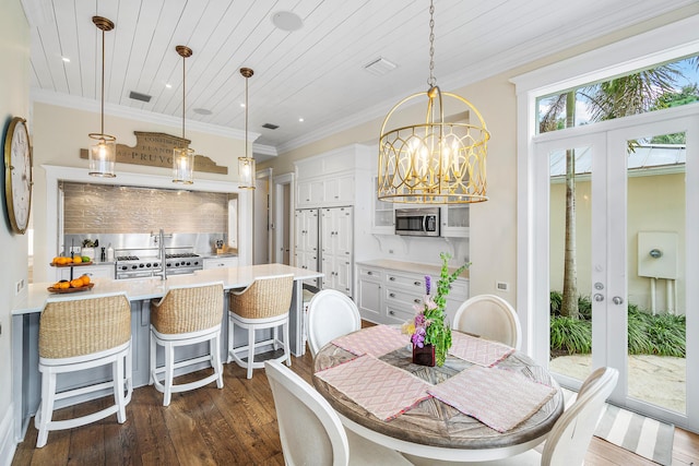 dining room with an inviting chandelier, ornamental molding, dark hardwood / wood-style floors, and wooden ceiling