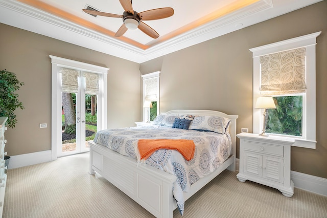 bedroom with light carpet, access to outside, ornamental molding, a raised ceiling, and ceiling fan