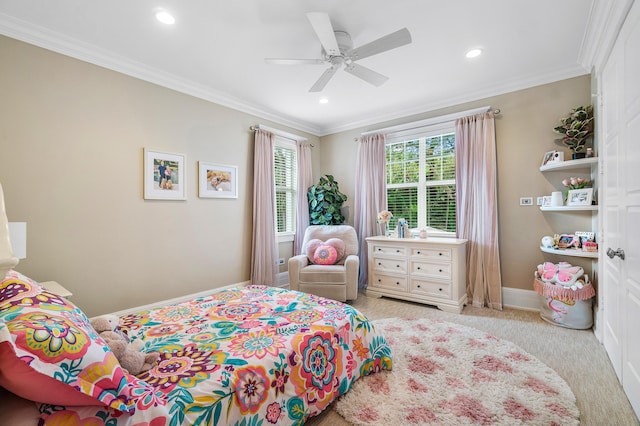 carpeted bedroom featuring ceiling fan and crown molding