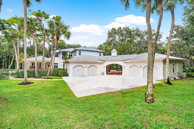 view of front of house with a front yard and a garage