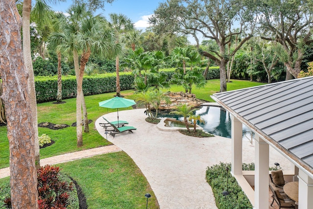 surrounding community featuring a lawn and a patio