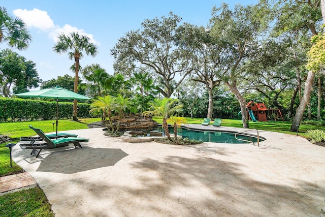 view of pool featuring a playground, a yard, and a patio