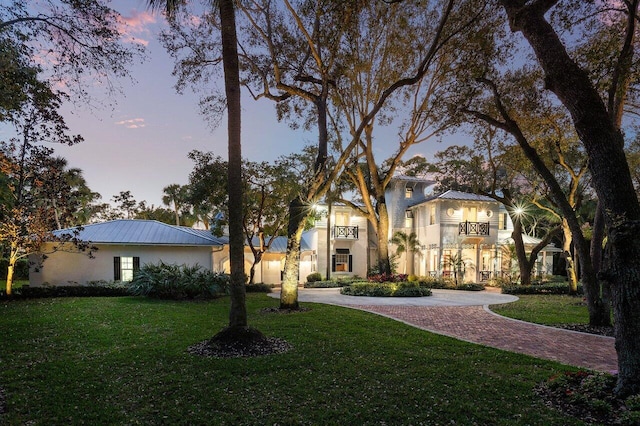 mediterranean / spanish house featuring a lawn