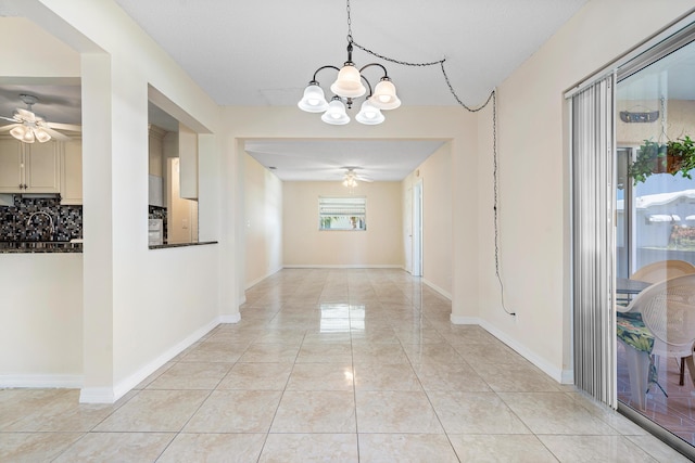 hallway featuring light tile patterned flooring, a textured ceiling, and a notable chandelier