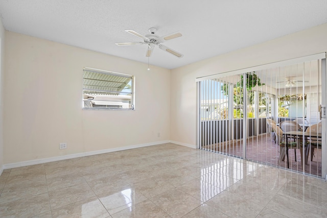 unfurnished room featuring a textured ceiling and ceiling fan