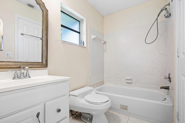 full bathroom featuring toilet, vanity, a textured ceiling, and tiled shower / bath