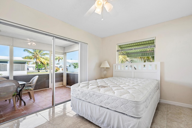 tiled bedroom featuring ceiling fan and a closet