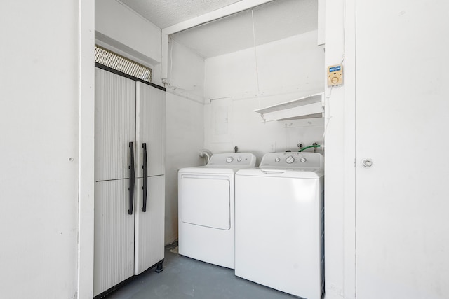 clothes washing area with washing machine and dryer