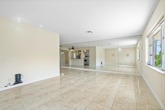 empty room featuring a textured ceiling