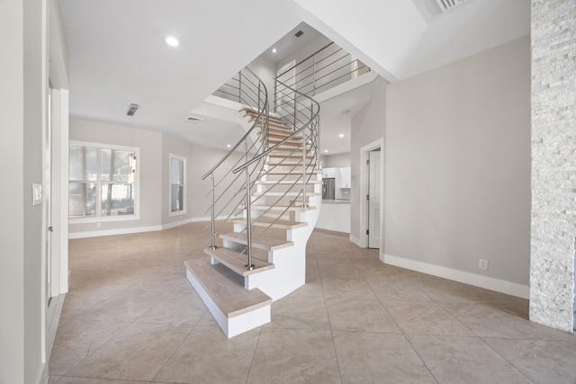 stairway with tile patterned floors