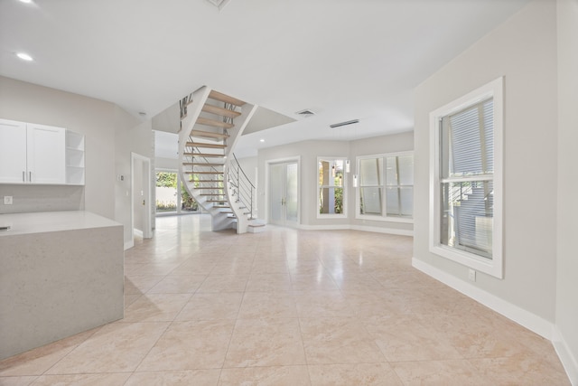 unfurnished living room with light tile patterned floors