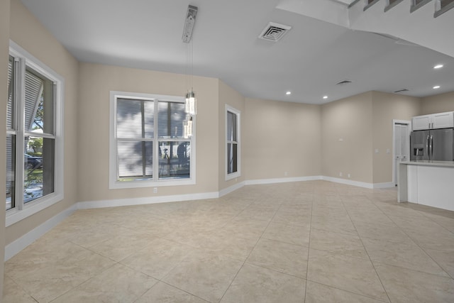 unfurnished room featuring light tile patterned floors