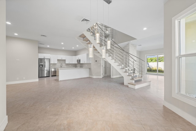 unfurnished living room featuring light tile patterned floors