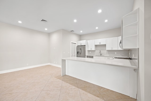 kitchen featuring white cabinets, sink, light tile patterned flooring, kitchen peninsula, and stainless steel appliances