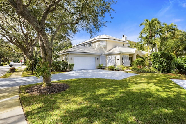 view of front of property featuring a front yard and a garage