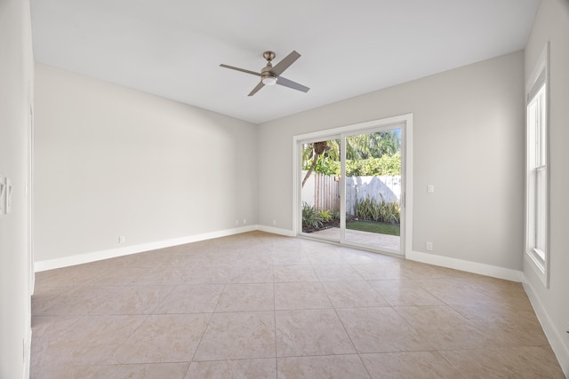 unfurnished room with light tile patterned floors and ceiling fan