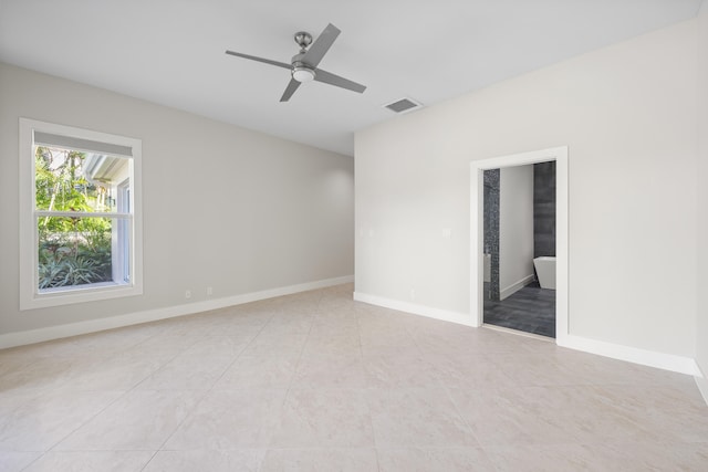 tiled spare room with ceiling fan