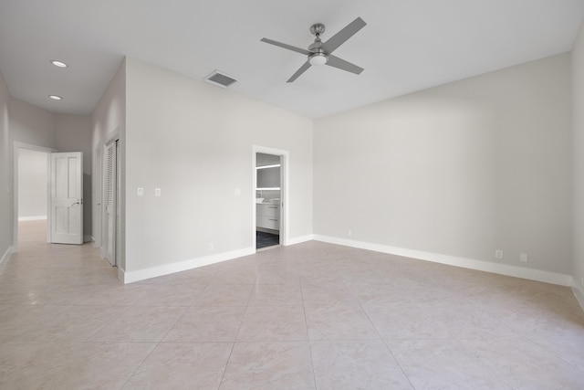 unfurnished bedroom featuring ceiling fan, a closet, and light tile patterned flooring