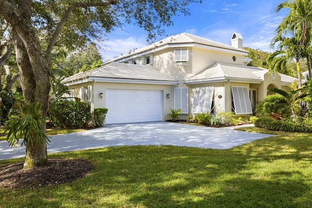 view of front of home with a front yard and a garage