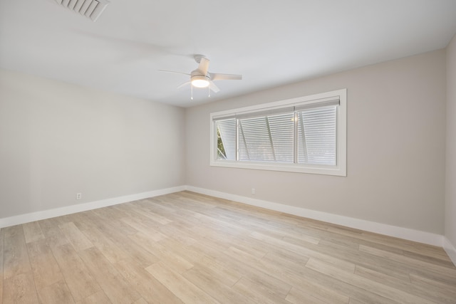 empty room with light hardwood / wood-style flooring and ceiling fan