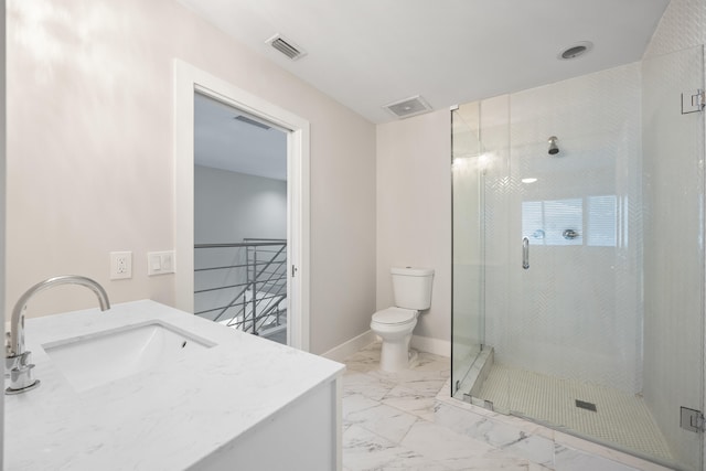 bathroom featuring vanity, toilet, and a shower with shower door