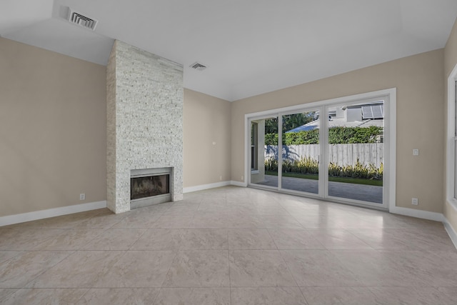 unfurnished living room featuring a fireplace and light tile patterned floors