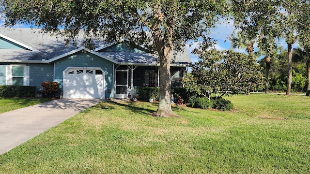 view of front of property with a garage and a front lawn