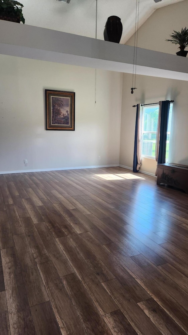 unfurnished room with high vaulted ceiling and dark hardwood / wood-style flooring