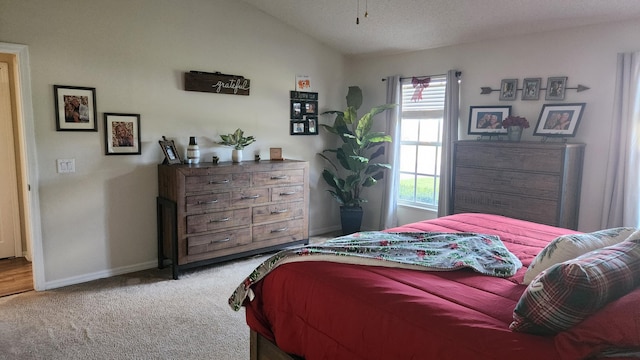 carpeted bedroom featuring lofted ceiling