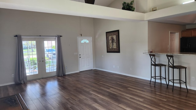 foyer featuring french doors, dark hardwood / wood-style flooring, and a high ceiling