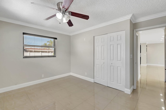 unfurnished bedroom featuring a closet, ceiling fan, crown molding, and a textured ceiling