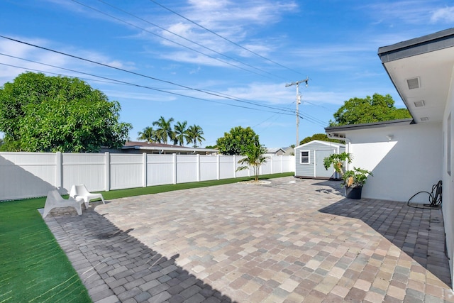 view of patio featuring a shed