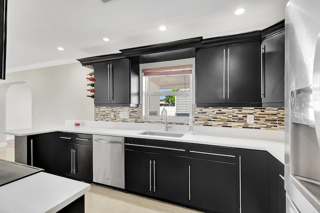 kitchen featuring decorative backsplash, appliances with stainless steel finishes, ornamental molding, sink, and light tile patterned flooring