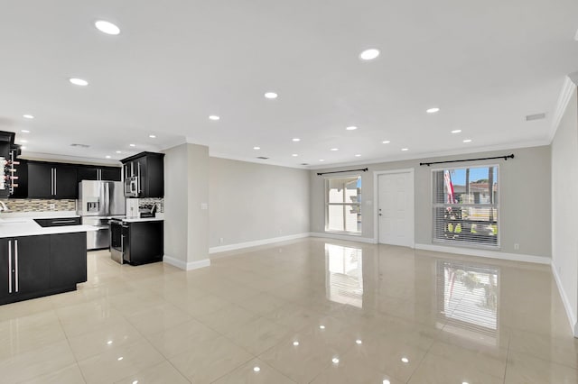 unfurnished living room with plenty of natural light, light tile patterned floors, and ornamental molding