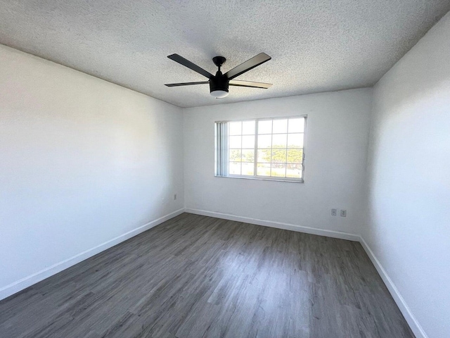 spare room with ceiling fan, dark wood-type flooring, and a textured ceiling