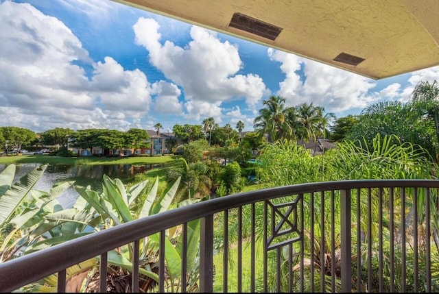 balcony featuring a water view and visible vents