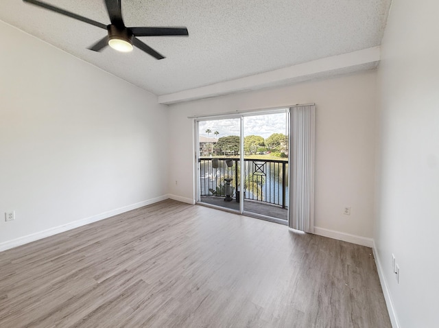 empty room featuring a textured ceiling, ceiling fan, light wood finished floors, and baseboards