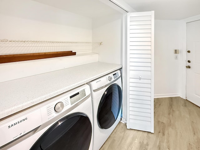 laundry room featuring laundry area, light wood finished floors, and washer and dryer