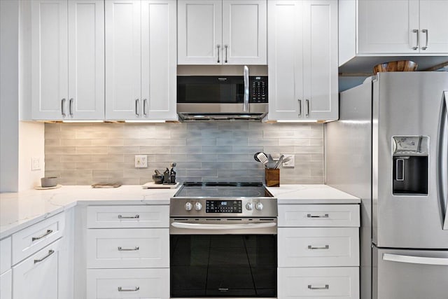 kitchen featuring appliances with stainless steel finishes, backsplash, and white cabinetry