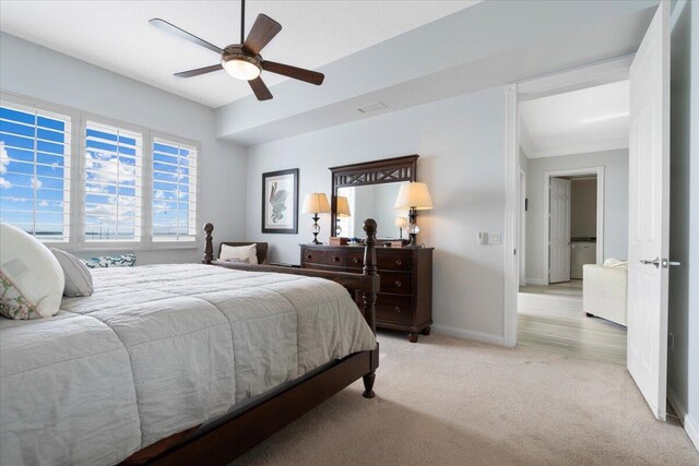 carpeted bedroom featuring ceiling fan and ornamental molding