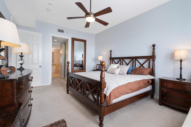 carpeted bedroom with ceiling fan and ensuite bathroom