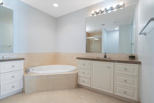 bathroom with tile patterned flooring, vanity, and shower with separate bathtub